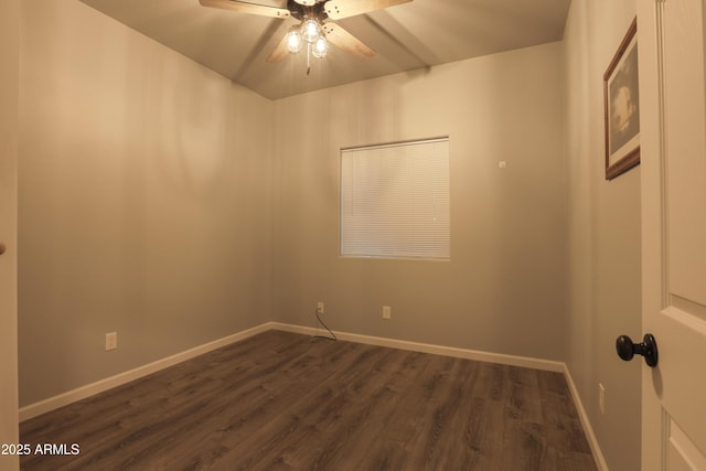 unfurnished room featuring dark wood-type flooring, ceiling fan, and baseboards