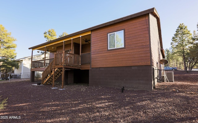 rear view of property with ceiling fan, crawl space, stairs, fence, and a wooden deck