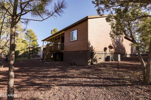 view of home's exterior featuring crawl space, stairs, fence, and a wooden deck