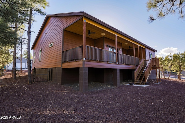 back of house featuring ceiling fan, stairway, a gate, fence, and a deck