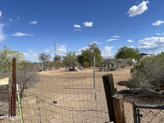 view of yard featuring fence and a playground