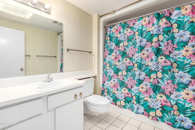 bathroom featuring tile patterned flooring, vanity, and toilet