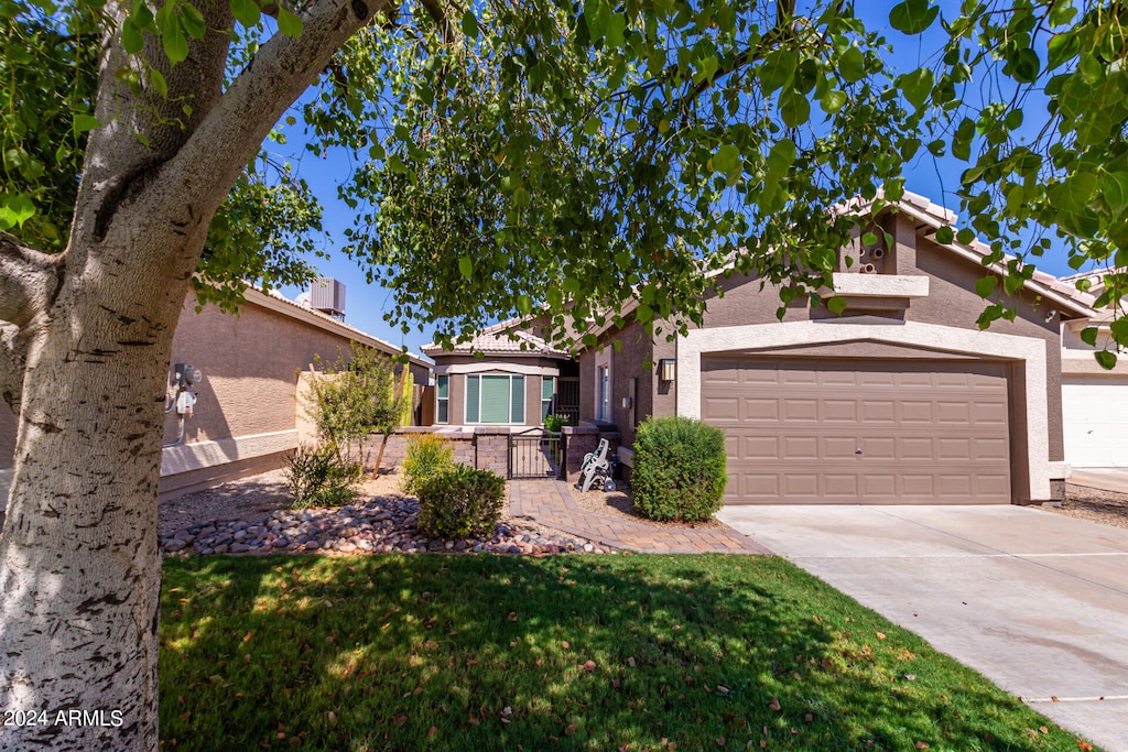 single story home with a front yard and a garage