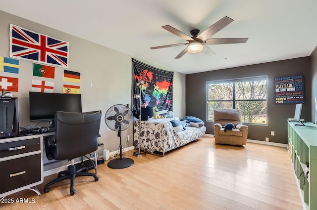 bedroom with ceiling fan and light hardwood / wood-style floors