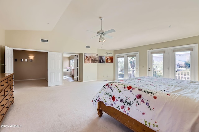 bedroom featuring ceiling fan, access to outside, light colored carpet, french doors, and vaulted ceiling