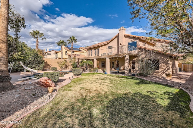 rear view of property with a yard and a patio