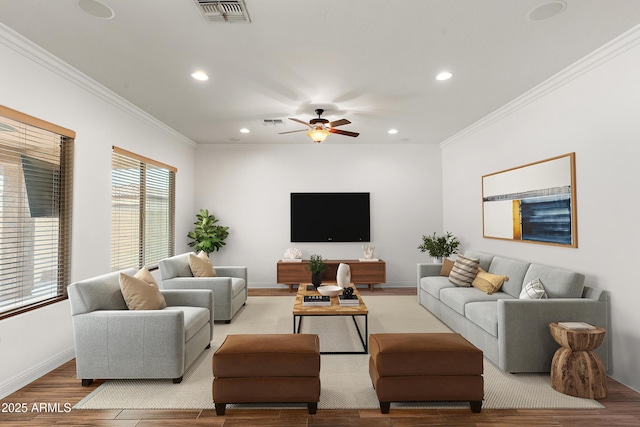 living room with wood finished floors, recessed lighting, a ceiling fan, baseboards, and crown molding