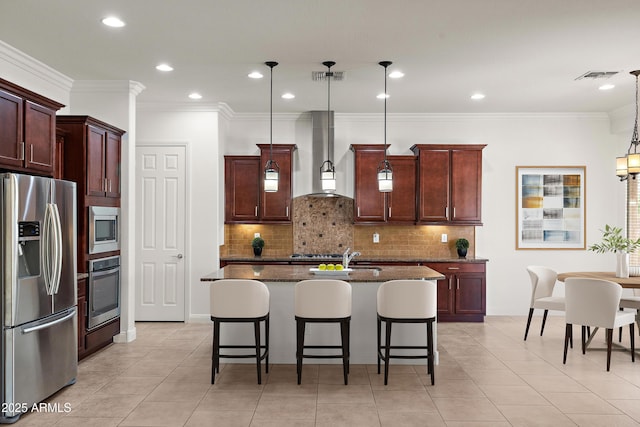 kitchen with stainless steel appliances, wall chimney range hood, backsplash, a breakfast bar, and dark stone counters