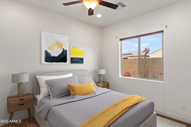 bedroom featuring baseboards, wood finished floors, recessed lighting, and ceiling fan