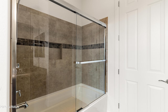bathroom featuring bath / shower combo with glass door