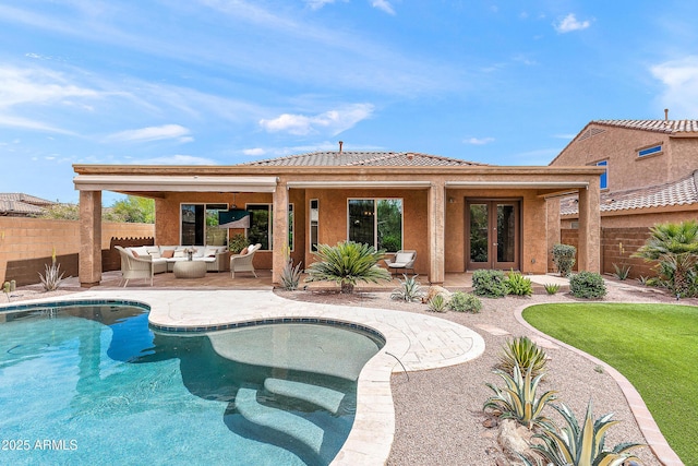 back of house with french doors, an outdoor living space, a fenced backyard, and a patio area