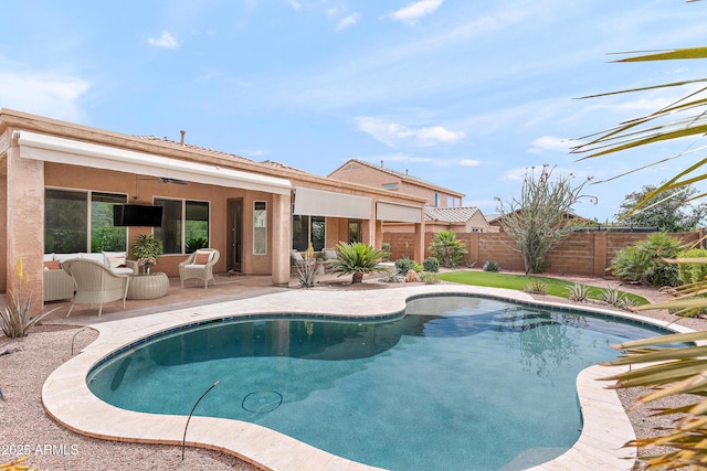 view of pool with a ceiling fan, fence, a patio area, and an outdoor living space
