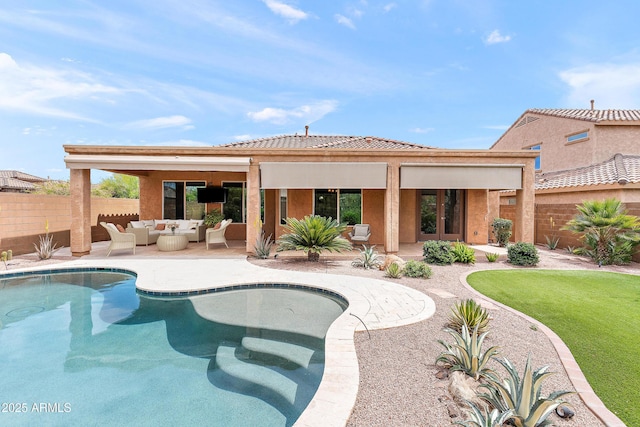 rear view of house featuring fence, an outdoor hangout area, a patio, and stucco siding