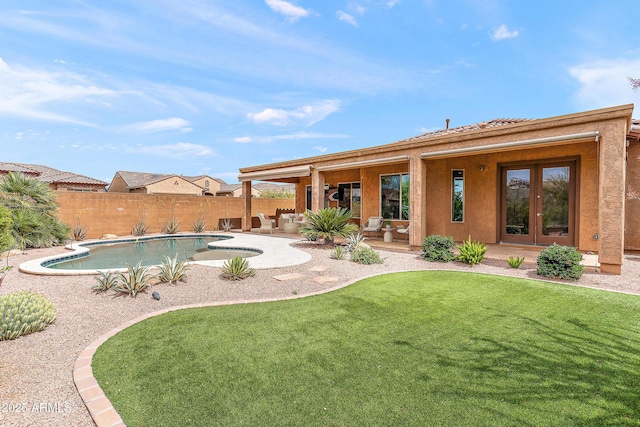 view of pool featuring a patio area and french doors