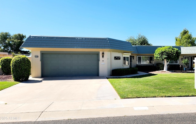 view of front of property featuring a garage and a front lawn