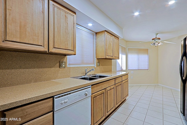 kitchen featuring black refrigerator, ceiling fan, sink, white dishwasher, and light tile patterned floors