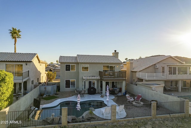 back of property with a patio area and a balcony