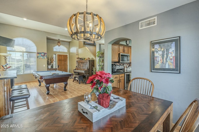 dining room featuring billiards and an inviting chandelier