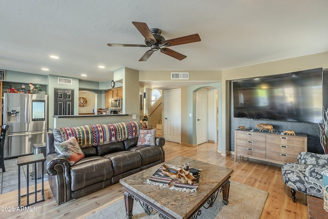 living room with light wood-type flooring and ceiling fan