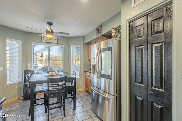 kitchen featuring ceiling fan, light tile patterned floors, and stainless steel fridge