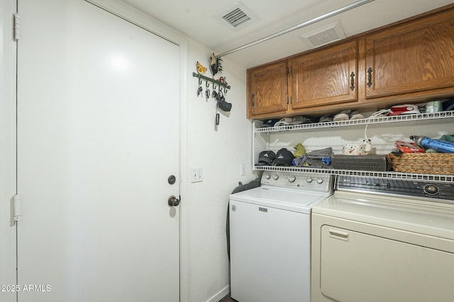 laundry area featuring cabinets and independent washer and dryer