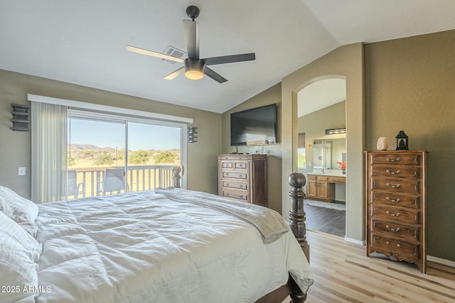 bedroom featuring ceiling fan, vaulted ceiling, access to outside, light hardwood / wood-style flooring, and connected bathroom