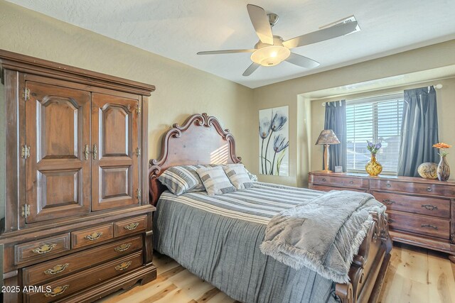 bedroom with ceiling fan and light wood-type flooring