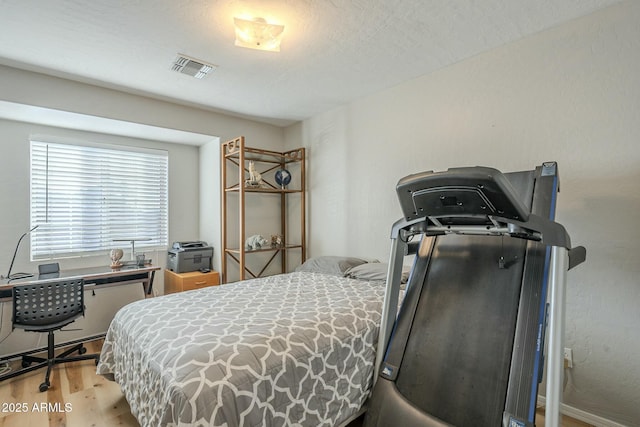 bedroom with light hardwood / wood-style floors