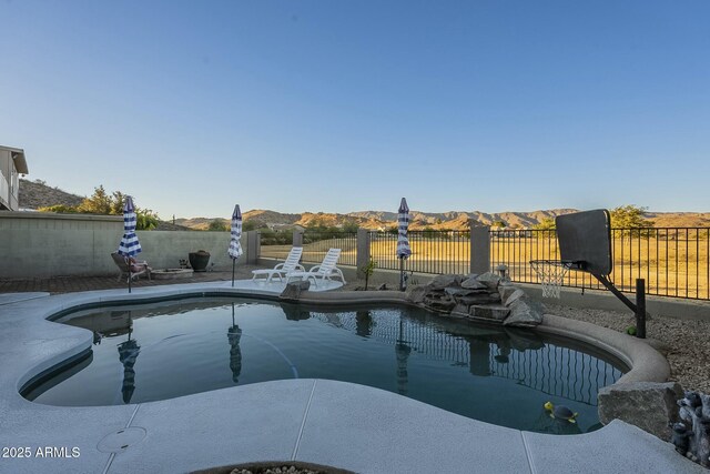 view of swimming pool featuring a mountain view and a patio area