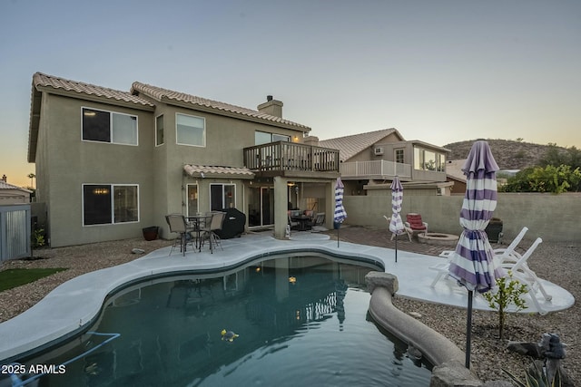 pool at dusk featuring a patio