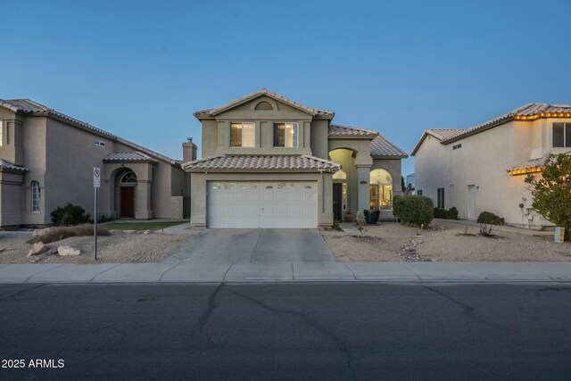 mediterranean / spanish-style home with a garage