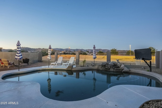 view of pool with a mountain view and a patio