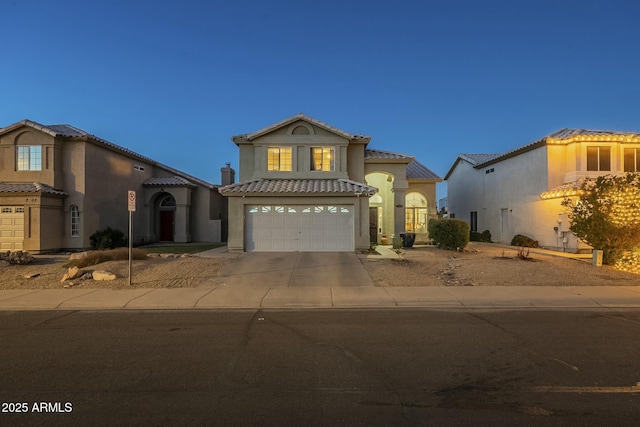 mediterranean / spanish home with a garage