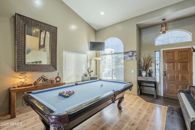 rec room with high vaulted ceiling, billiards, and hardwood / wood-style floors