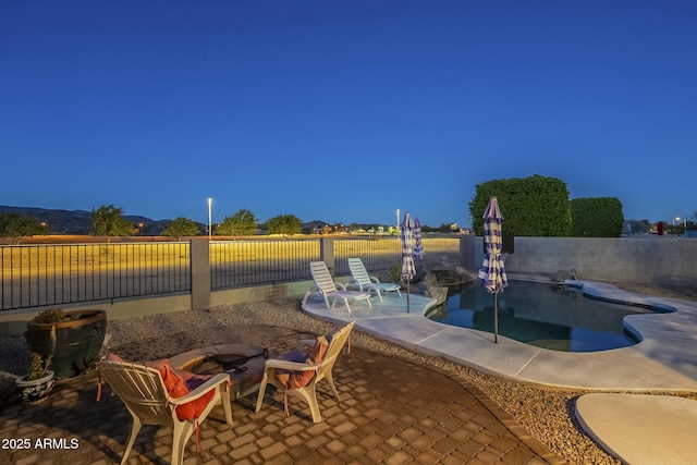 exterior space featuring a fenced in pool and an outdoor fire pit