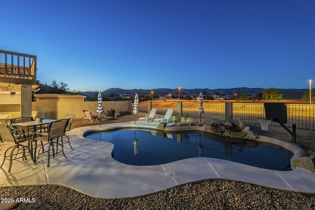 view of pool featuring a mountain view and a patio