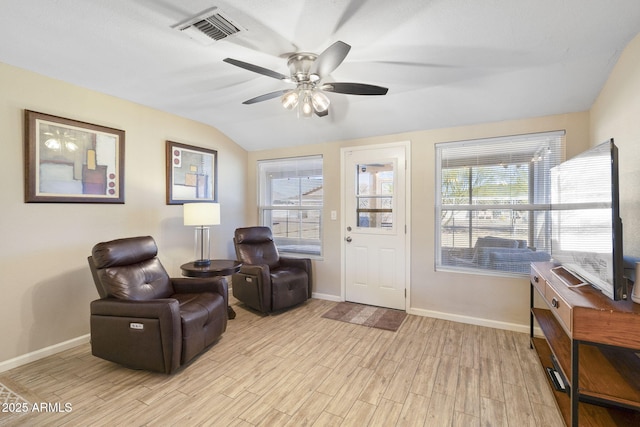 sitting room featuring ceiling fan, light hardwood / wood-style flooring, and lofted ceiling