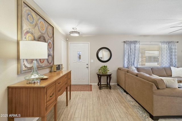 foyer with ceiling fan and light wood-type flooring