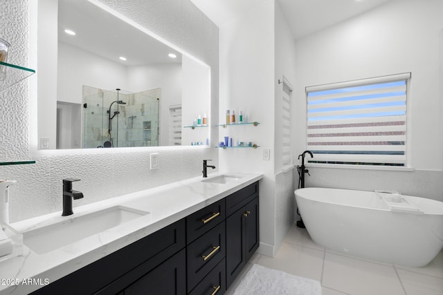 bathroom with tile patterned floors, vanity, and shower with separate bathtub