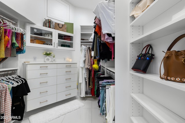 walk in closet with light tile patterned flooring