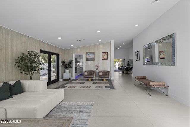 tiled living room featuring vaulted ceiling, french doors, and wood walls