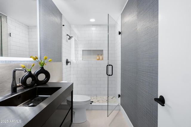 bathroom with vanity, tile patterned floors, toilet, and walk in shower