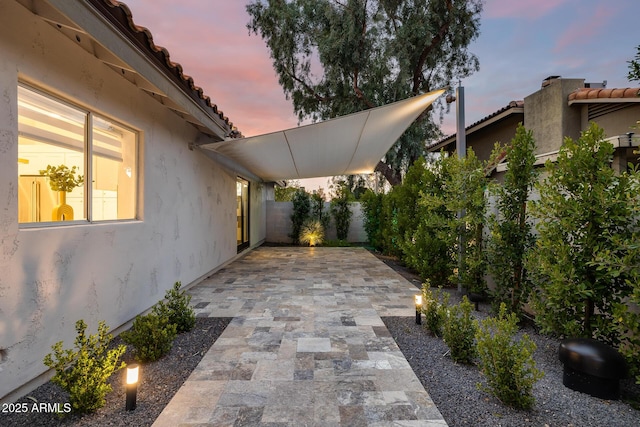 view of patio terrace at dusk