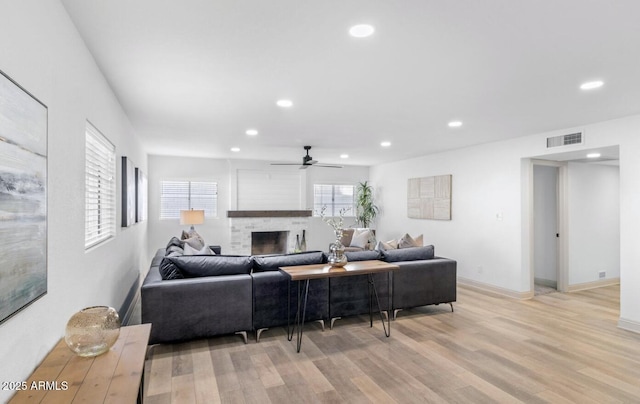 living room featuring ceiling fan and light hardwood / wood-style floors