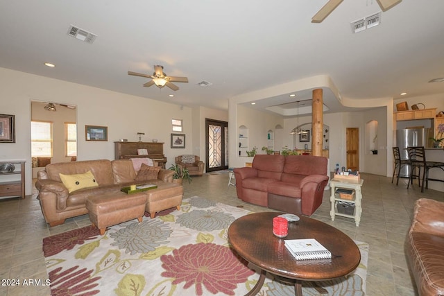 tiled living room with ceiling fan