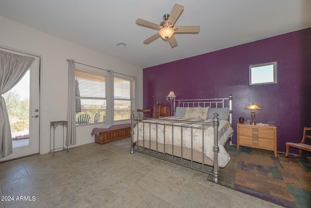 bedroom with tile floors, ceiling fan, and access to exterior