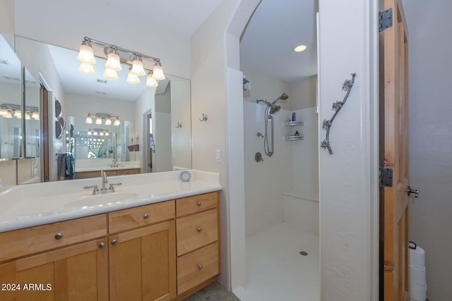 bathroom featuring a shower and vanity