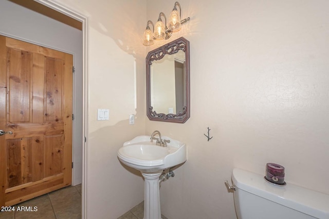 bathroom with tile flooring and toilet