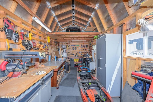 miscellaneous room featuring a workshop area and lofted ceiling