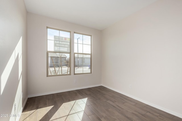 spare room with wood-type flooring